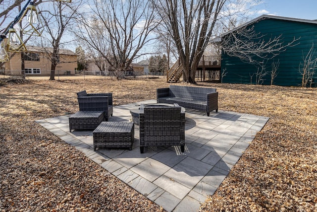 view of patio / terrace featuring a deck, stairway, and fence