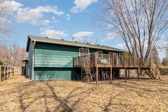 back of house with stairway, a deck, and fence