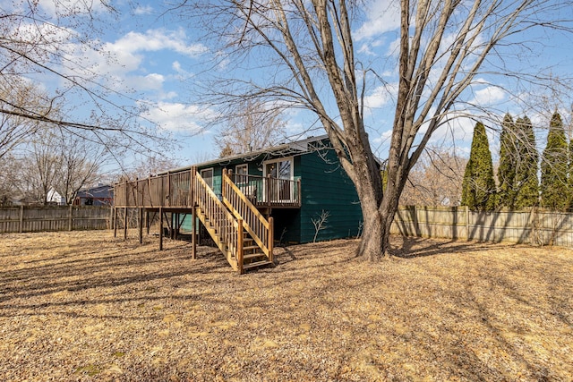 exterior space featuring stairway, a fenced backyard, and a wooden deck