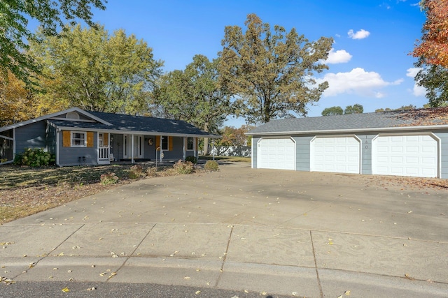 single story home with covered porch and a detached garage