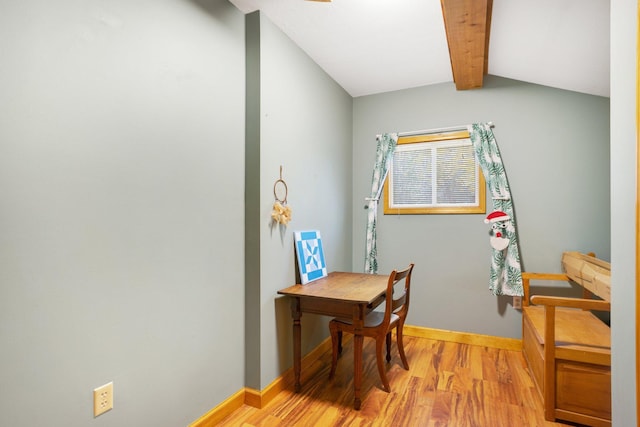 office area featuring light wood-type flooring, vaulted ceiling with beams, and baseboards