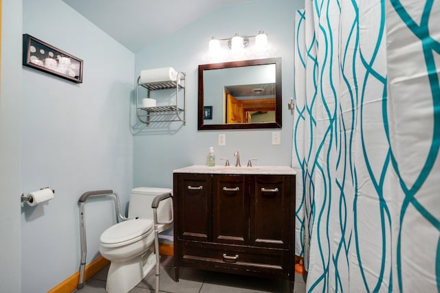 bathroom featuring lofted ceiling, vanity, toilet, and tile patterned floors