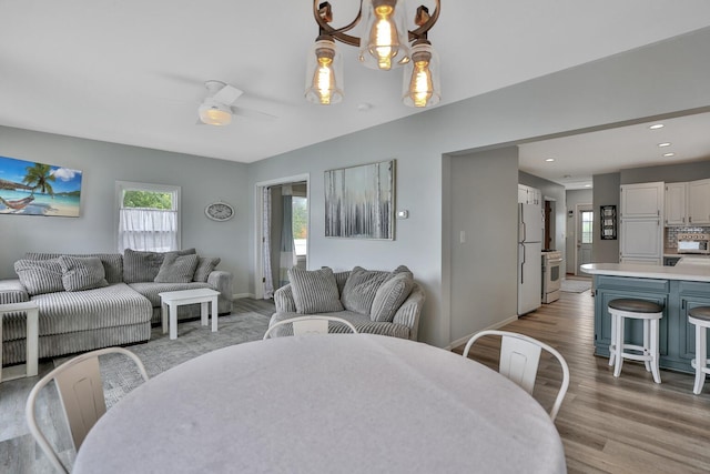 dining area featuring recessed lighting, a healthy amount of sunlight, ceiling fan, and light wood finished floors