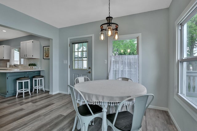 dining room with light wood finished floors and baseboards