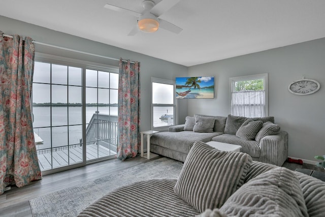 living area featuring a water view, plenty of natural light, and wood finished floors