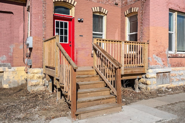 property entrance featuring brick siding