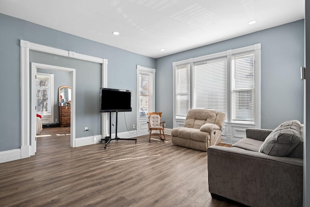 living room featuring baseboards, wood finished floors, and recessed lighting