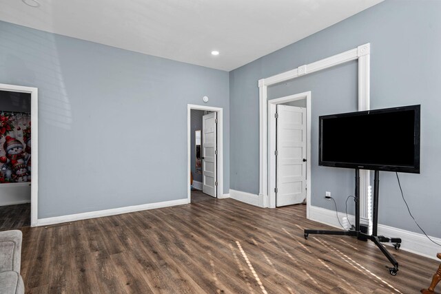 unfurnished living room with baseboards, wood finished floors, and recessed lighting