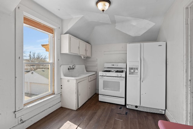 kitchen featuring dark wood-style floors, light countertops, white cabinets, a sink, and white appliances