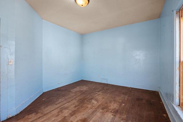 empty room with hardwood / wood-style floors