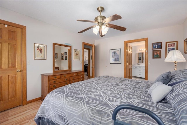 bedroom with light wood finished floors, connected bathroom, a ceiling fan, and baseboards