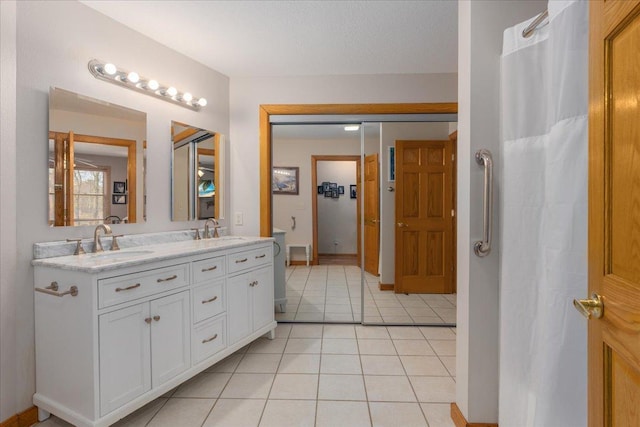 full bath with tile patterned flooring, a sink, and double vanity