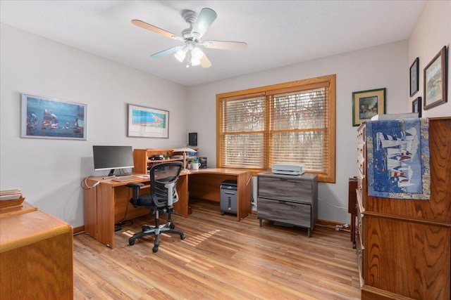 office area featuring light wood-style flooring, baseboards, and ceiling fan