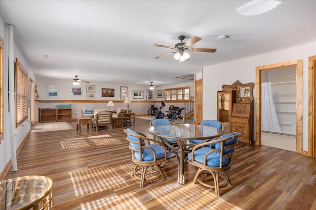 dining area with wood finished floors and a ceiling fan