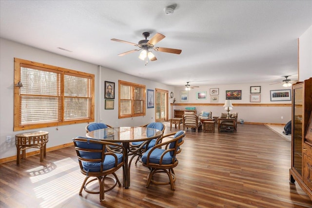 dining room with baseboards, wood finished floors, and a healthy amount of sunlight