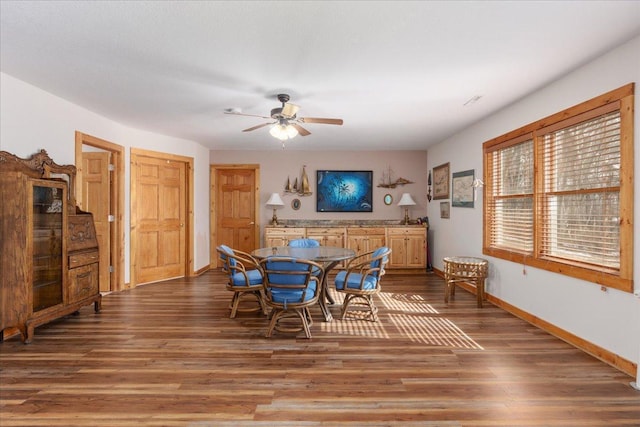 dining room featuring ceiling fan, baseboards, and wood finished floors