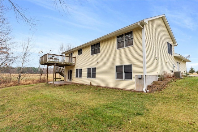 back of house featuring stairway, cooling unit, a lawn, and a deck