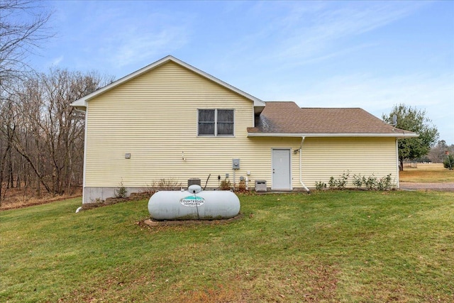 rear view of house with a yard