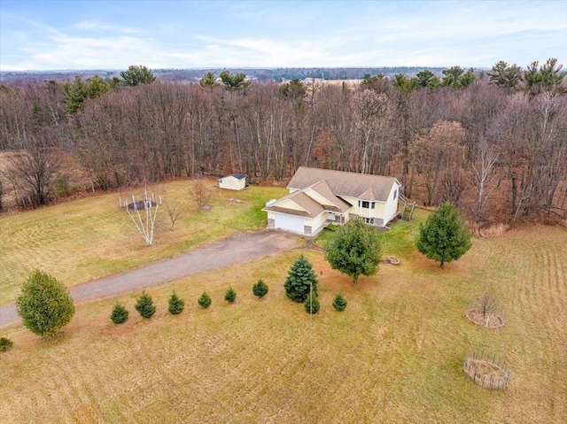 birds eye view of property with a forest view