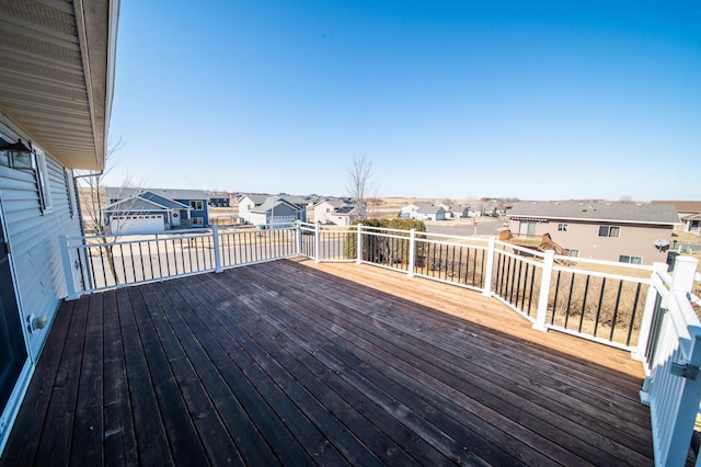 wooden terrace featuring a residential view and an outbuilding