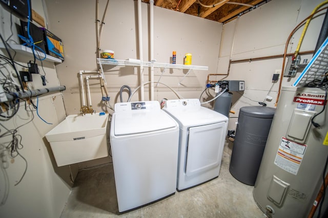 laundry area with laundry area, independent washer and dryer, a sink, and electric water heater