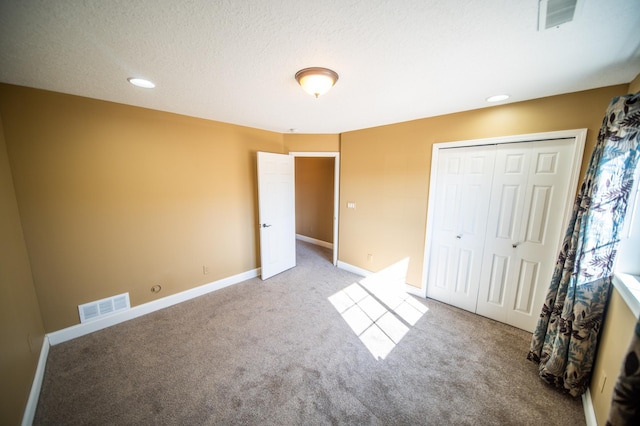 unfurnished bedroom featuring baseboards, visible vents, and carpet flooring