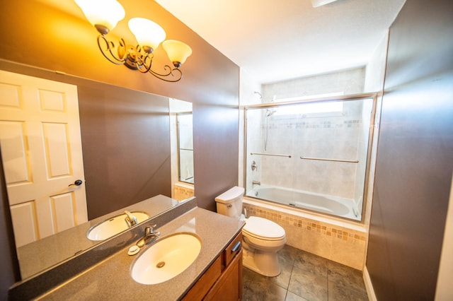 full bathroom featuring toilet, tile patterned floors, vanity, and tiled shower / bath combo