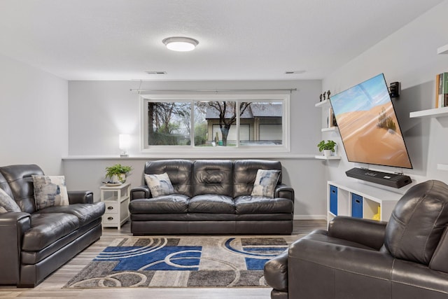 living room with wood finished floors and visible vents