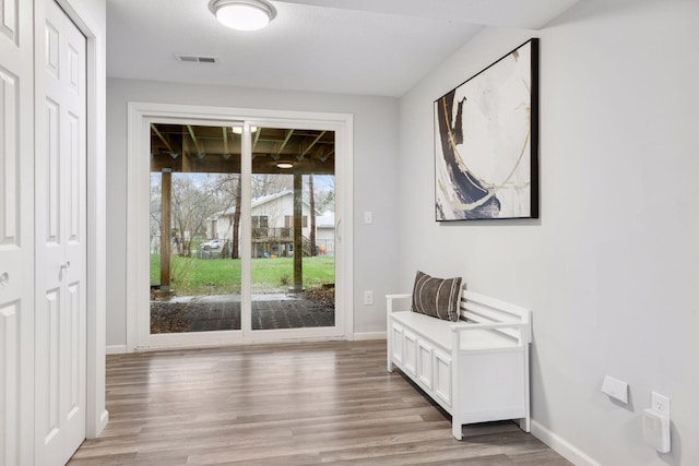entryway featuring visible vents, baseboards, and light wood-type flooring