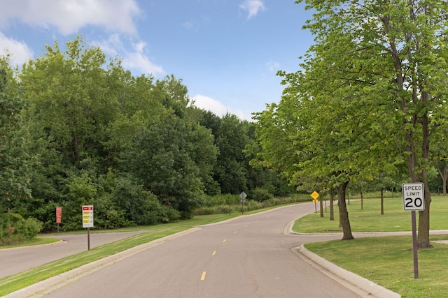 view of street with traffic signs and curbs