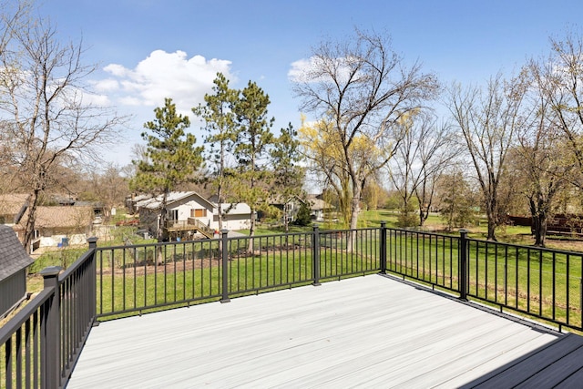 wooden terrace featuring a yard and a residential view