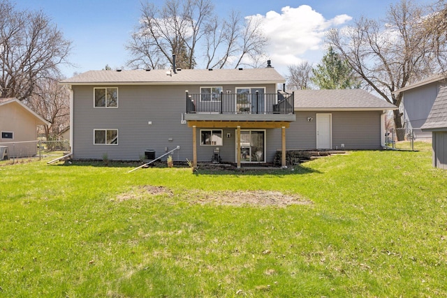 rear view of house with central air condition unit, fence, a yard, and a deck