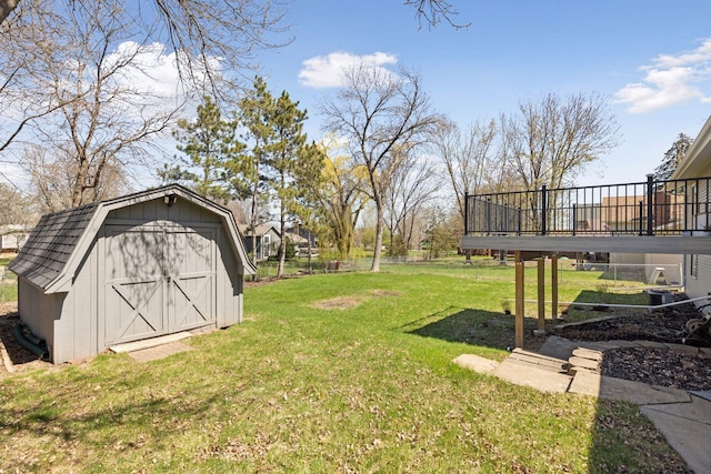 view of yard with a deck, an outbuilding, and a storage unit