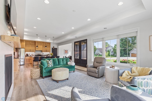 living room with light wood-type flooring and recessed lighting