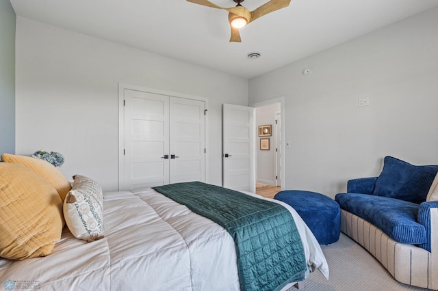 bedroom with ceiling fan, visible vents, and a closet