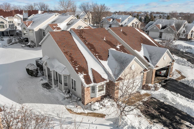 snowy aerial view featuring a residential view