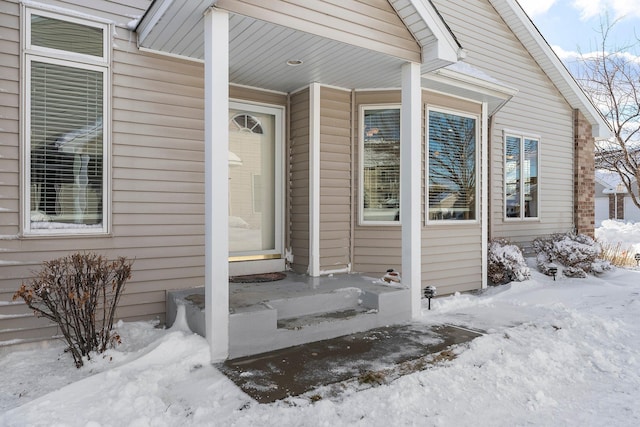 view of snow covered property entrance