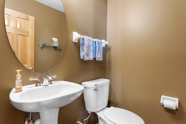 bathroom featuring toilet and a sink