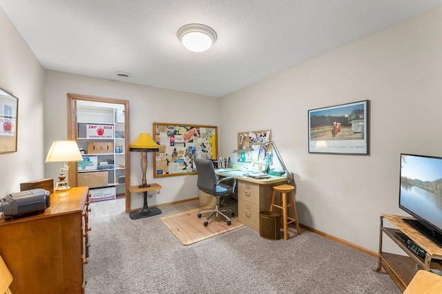 carpeted office space featuring visible vents, a textured ceiling, and baseboards