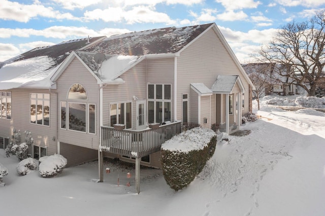 snow covered property with a deck