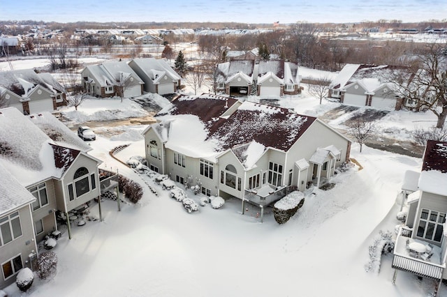 snowy aerial view featuring a residential view