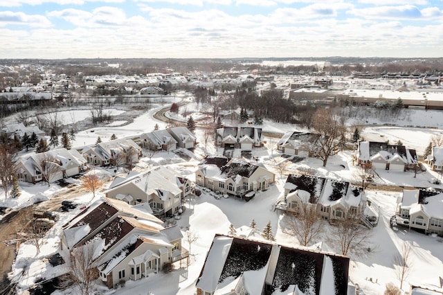 snowy aerial view with a residential view