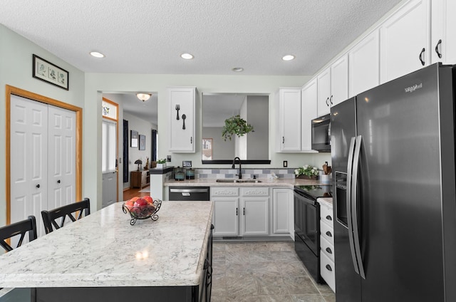 kitchen with dishwashing machine, a sink, black range with electric stovetop, fridge with ice dispenser, and a center island