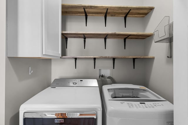 laundry area with washer and dryer and cabinet space