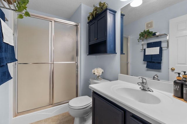 bathroom with a shower stall, tile patterned floors, and a textured ceiling