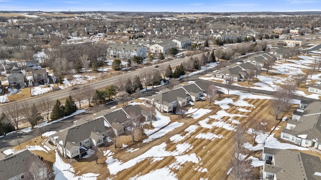 snowy aerial view with a residential view