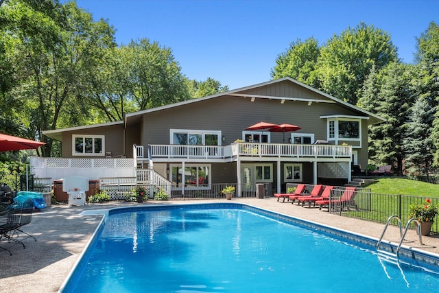 rear view of property with fence, stairs, a patio area, a deck, and cooling unit