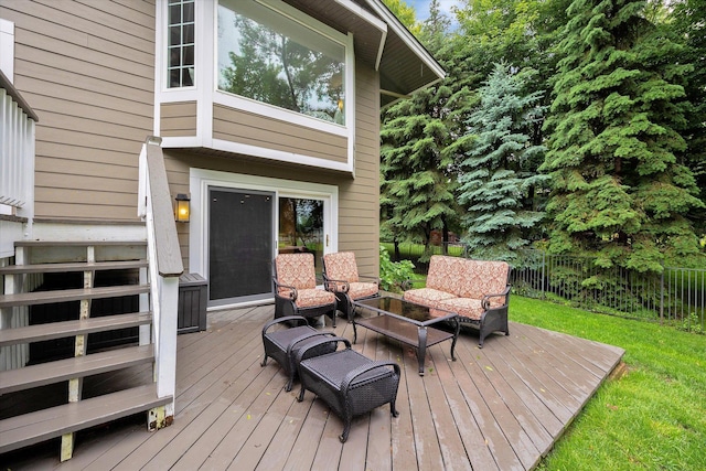 wooden terrace featuring a lawn, outdoor lounge area, and fence