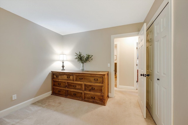 corridor with light carpet and baseboards
