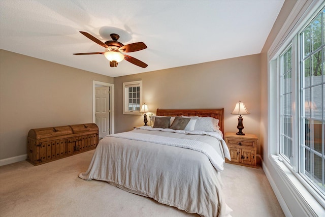 bedroom featuring carpet, baseboards, and a ceiling fan